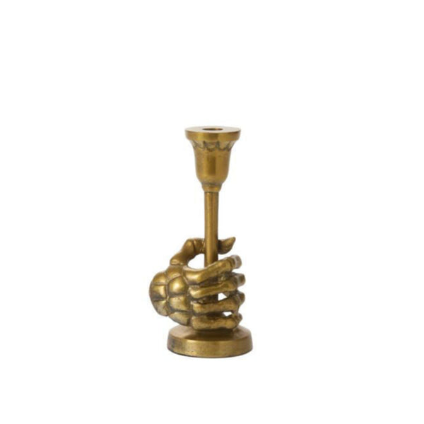 Brass candle holder shaped like a hand holding a candle on a white background
