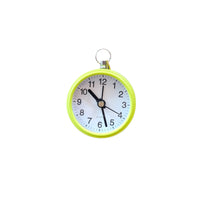 Round clock with a green casing.