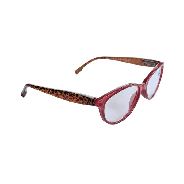 Red eyeglasses with leopard print arm on a white sheet of paper