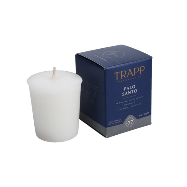 White candle with a blue Trapp Palo Santo box on a white background