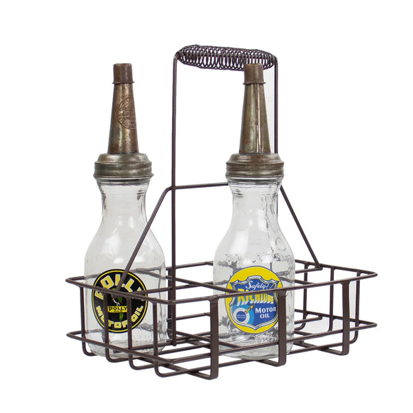 Two vintage-style oil bottles with metal dispensers in a wire carrier on a white background