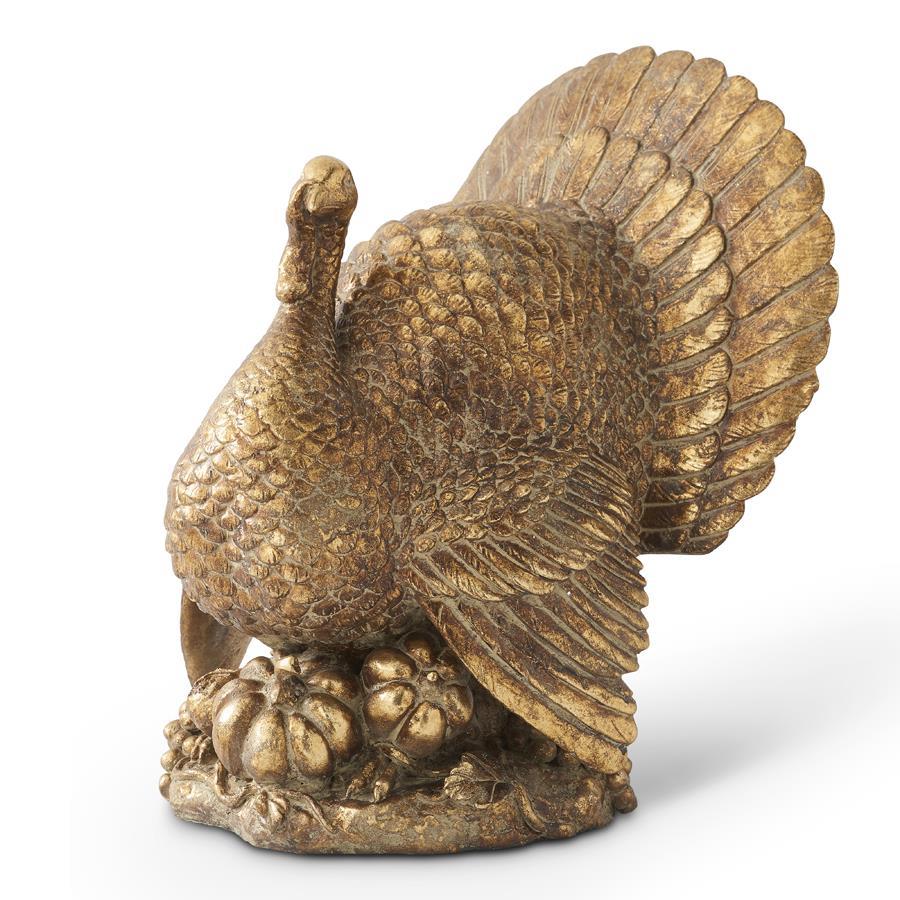 Bronze statue of a turkey with outstretched wings on a white background