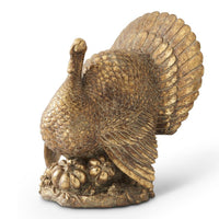 Bronze statue of a turkey with outstretched wings on a white background