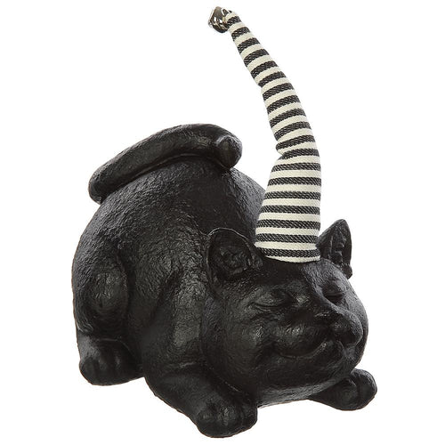 A black cat figurine lying down with its tail raised, wearing a black and white striped party hat, shown on a plain white background.