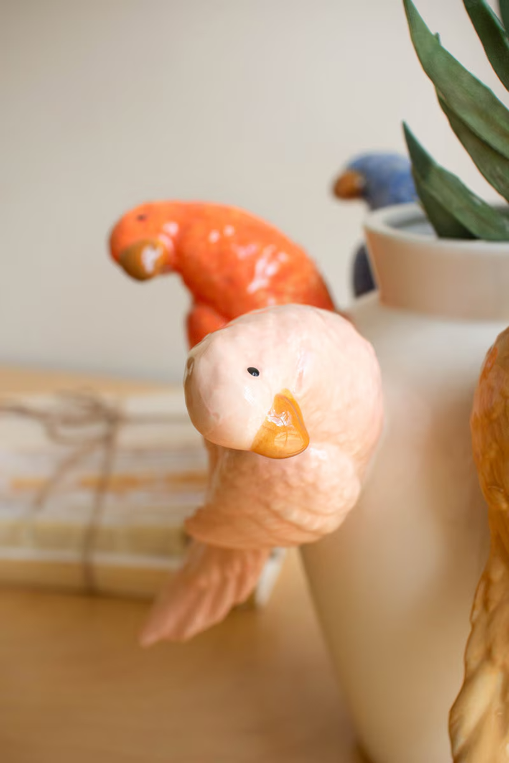 Decorative parrot on a vase with a blurred background