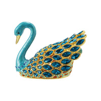 Decorative swan figurine with blue and gold details on a white background