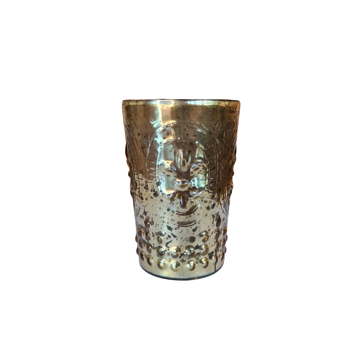 A hammered metallic gold cup with a textured, embossed floral pattern, sitting on a white surface in a blurred shop environment.
