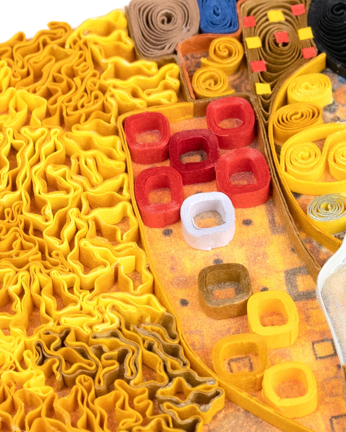 Closeup of a section of a quilled greeting card resembling Klimt's 'Lady in Gold'