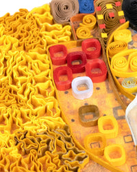 Closeup of a section of a quilled greeting card resembling Klimt's 'Lady in Gold'