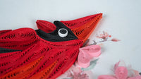 Close up of a quilled cardinal on a greeting card.