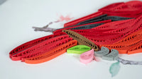 Close up of quilled cardinal tail on a greeting card.