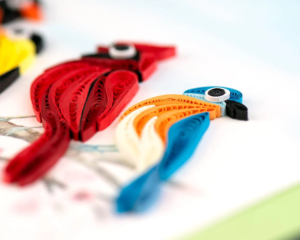 Close up of a greeting card featuring a quilled cardinal and bluebird