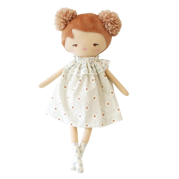 Plush doll with brown hair and a patterned dress on a white background