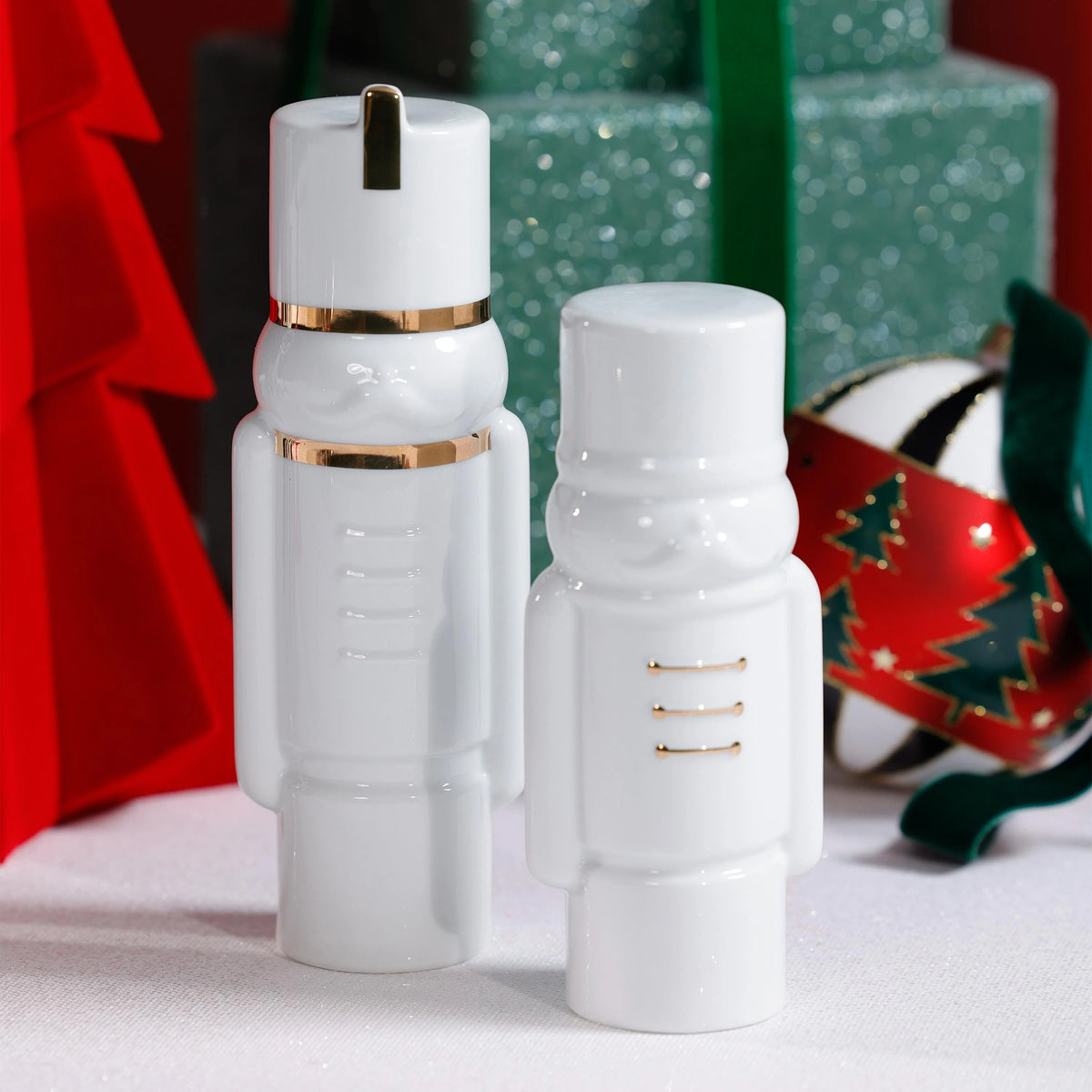 Two white soldier figurines with gold accents on a festive background.