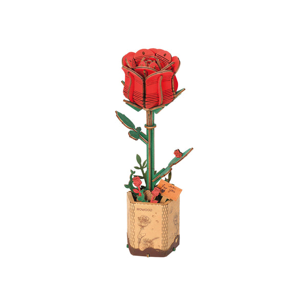 Red rose-shaped object in a decorative pot on a white background