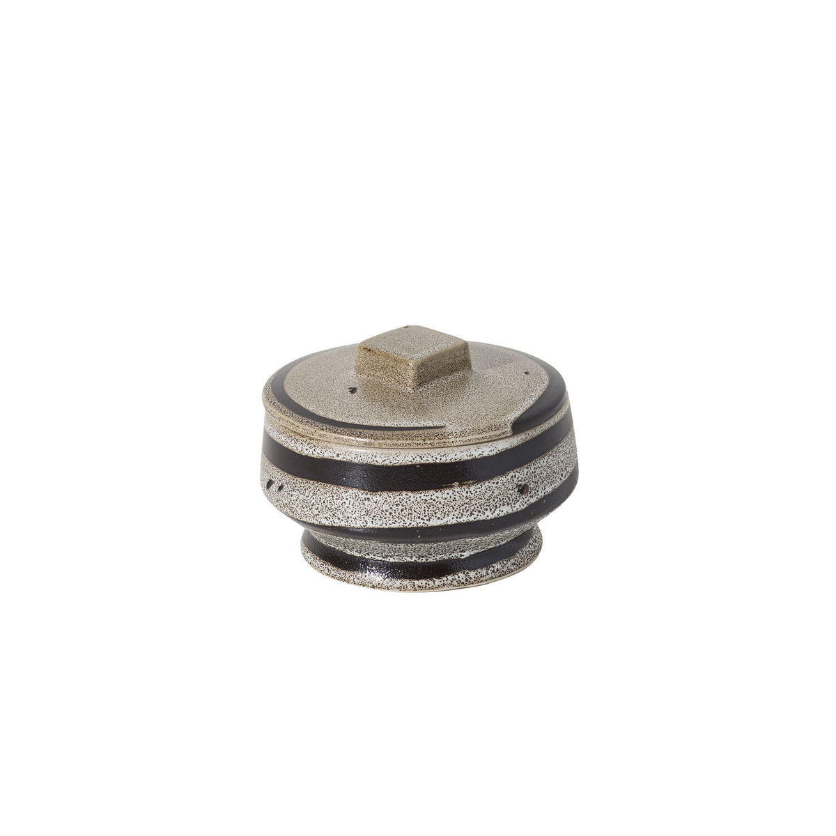 A circular lidded box with a square knob on the top on a white background.