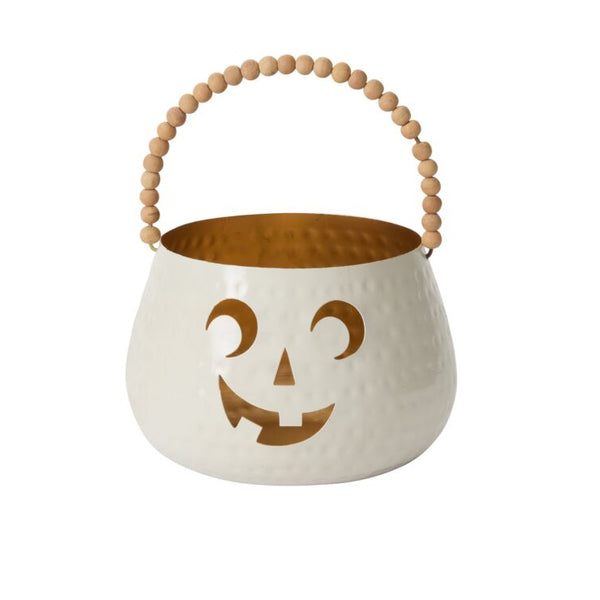 Metal Halloween candy bucket in white with pumpkin face design and wooden handle on a white background