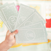 Child holding play money on a colorful background