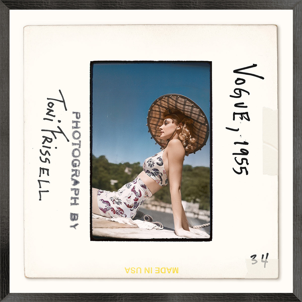 Vintage photograph of a woman wearing a swimsuit and a straw hat with text indicating 'Toni Frissell, Photograph by' and 'Vogue 1955'.