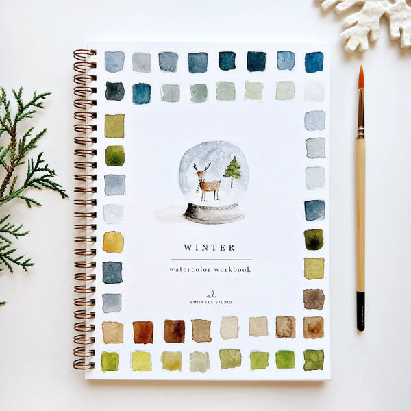 Winter watercolor workbook with a snow globe illustration and color swatches on a white background.