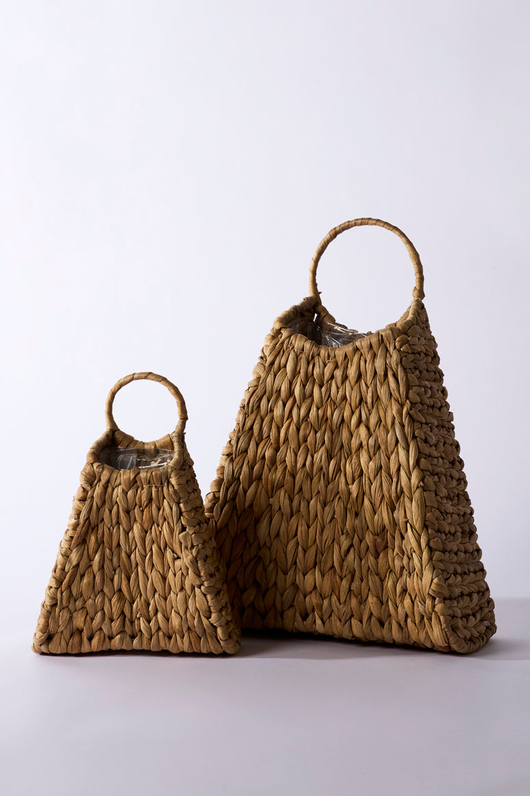 Two woven bags, one larger and one smaller, on a light gray background.